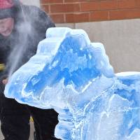 person working on michigan ice sculpture